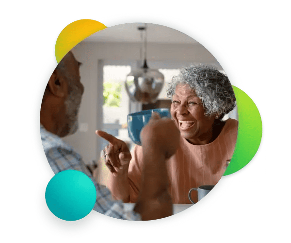 elderly-couple-laughing-and-drinking-coffee-together